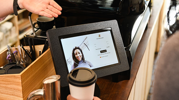 Image 6 shows Mastercard's facial recognition checkout technology demonstrated by a tablet with a woman's face on it. There's a white circle around her face showing the technology's facial recognition capability.