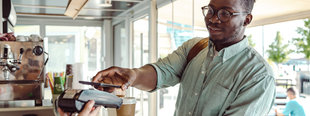 Man paying for coffee using a smartphone